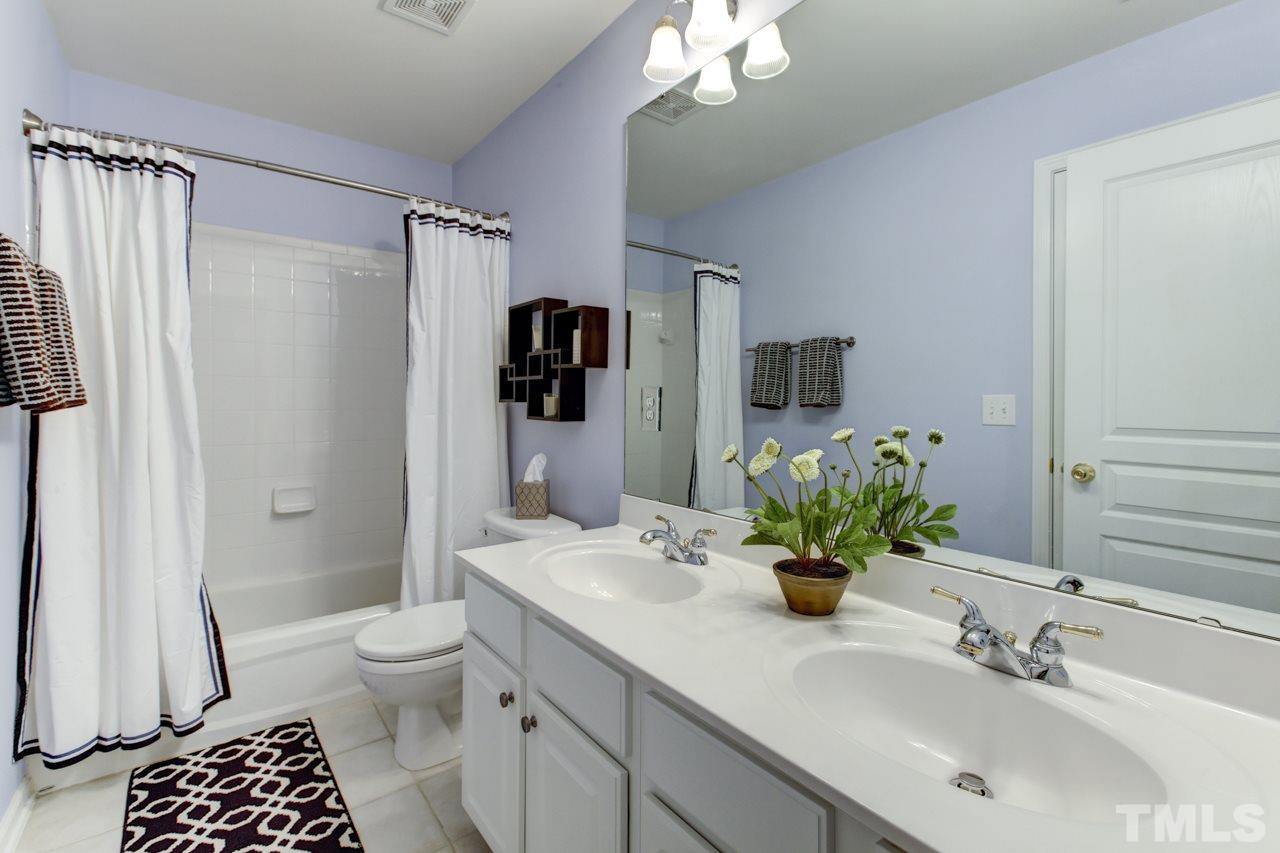 3743 Old Post Road Raleigh, NC 27612 - Photo 20 of 25 a bathroom with a sink a toilet and shower