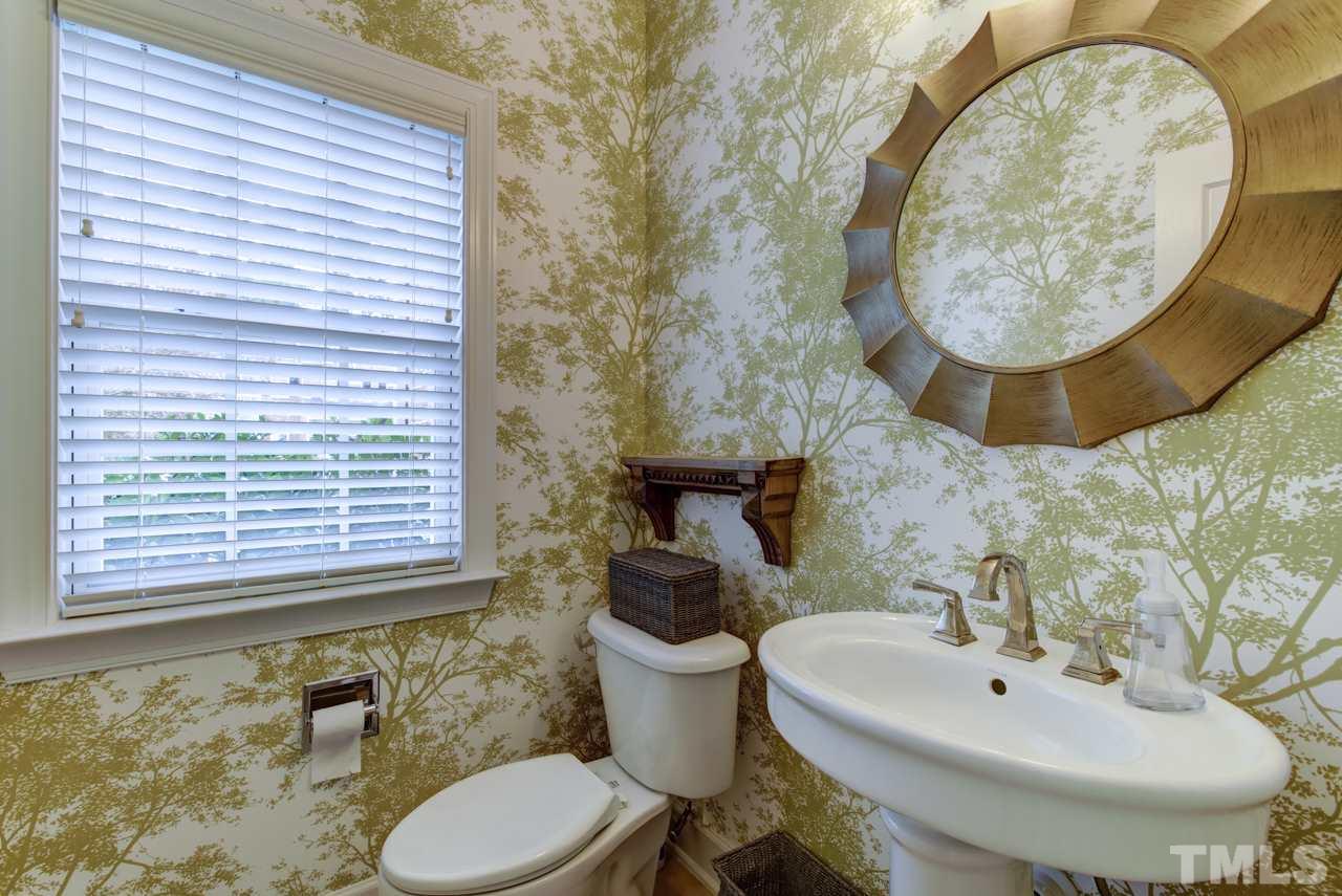 3743 Old Post Road Raleigh, NC 27612 - Photo 21 of 25 a bathroom with a sink and mirror