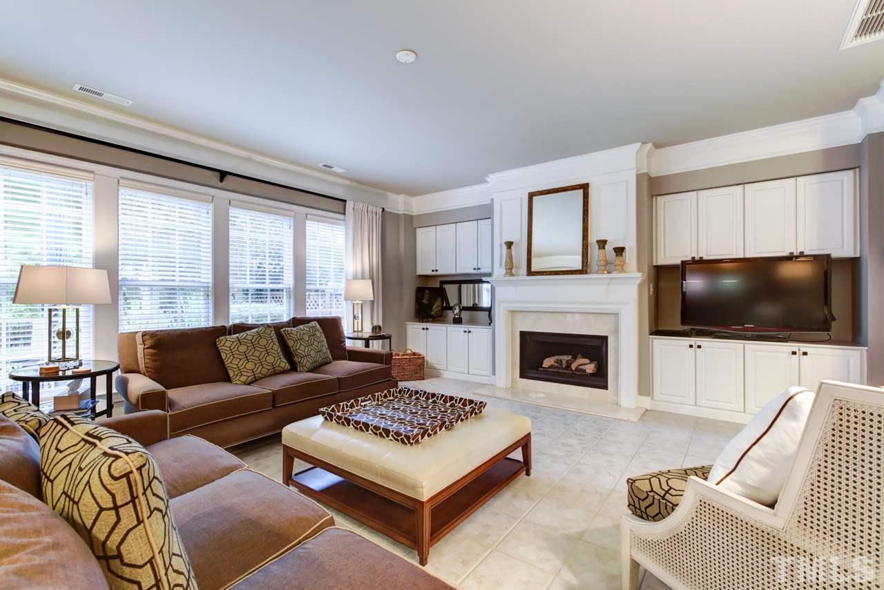 3743 Old Post Road Raleigh, NC 27612 - Photo 7 of 25 a living room with furniture a flat screen tv and a fireplace