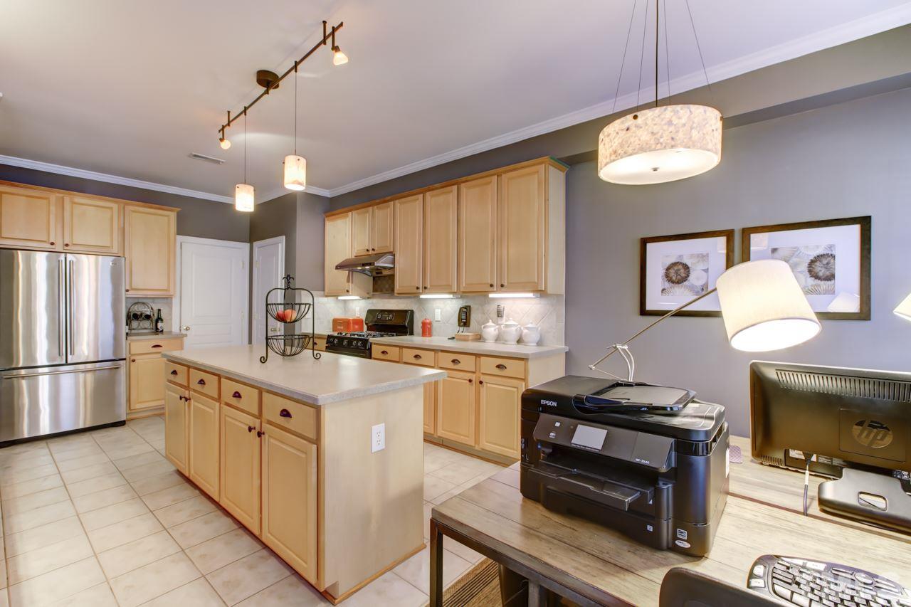 3743 Old Post Road Raleigh, NC 27612 - Photo 9 of 25 a kitchen with kitchen island granite countertop a sink a counter top space cabinets stainless steel appliances and a window