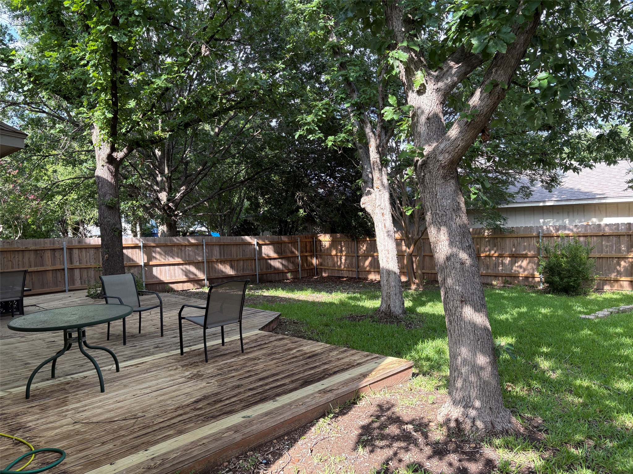 14707 Single Trace Austin, TX 78728 - Photo 5 of 17 A generous backyard offers a wooden deck and ample green space, perfect for outdoor enjoyment.