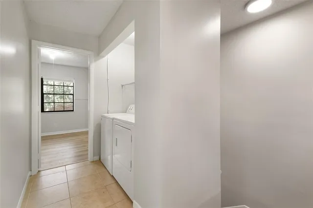 a view of hallway with windows and cabinet