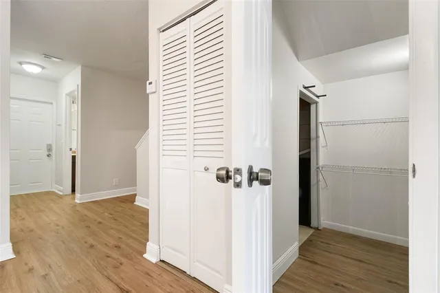 a view of a room with wooden floor