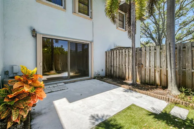a view of backyard with tub and potted plants