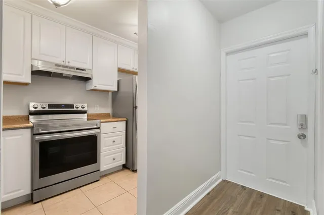 a stove top oven sitting inside of a kitchen