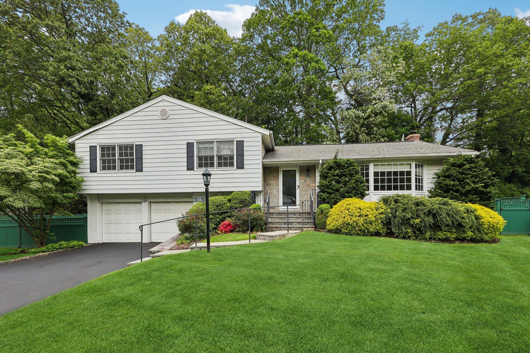 56 Rolling Way New Rochelle, NY 10804 - Photo 1 of 1 a front view of a house with a garden and porch