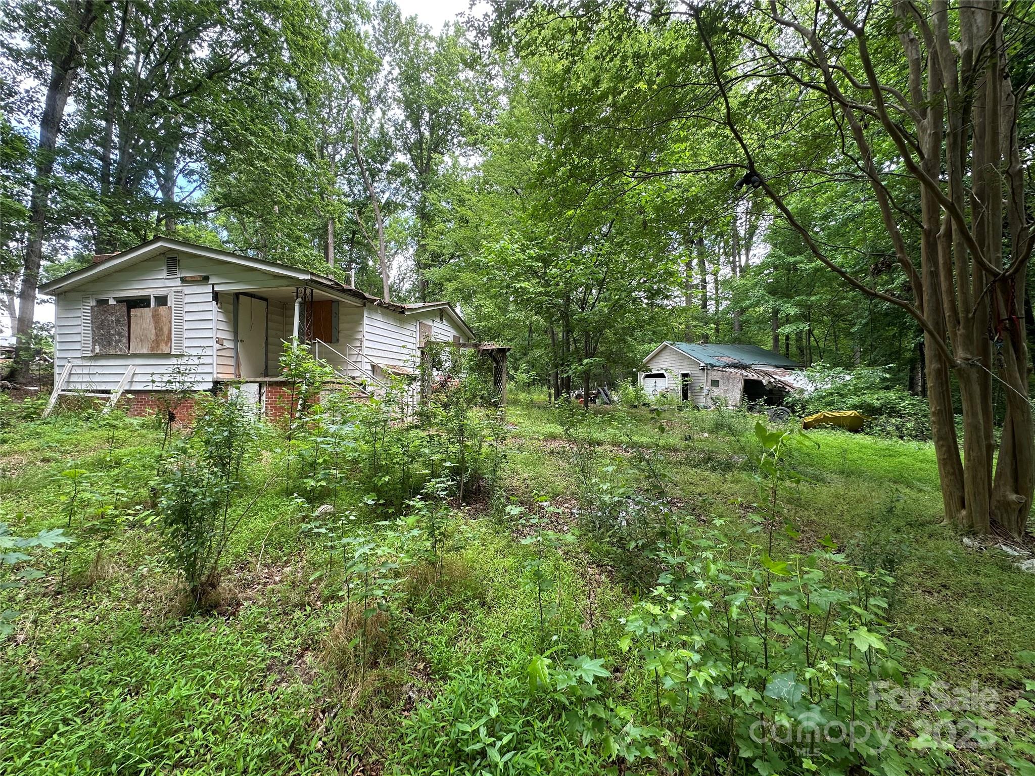 455 Running Brook Road Midland, NC 28107 - Photo 5 of 6 a view of a tree in front of a house with a yard