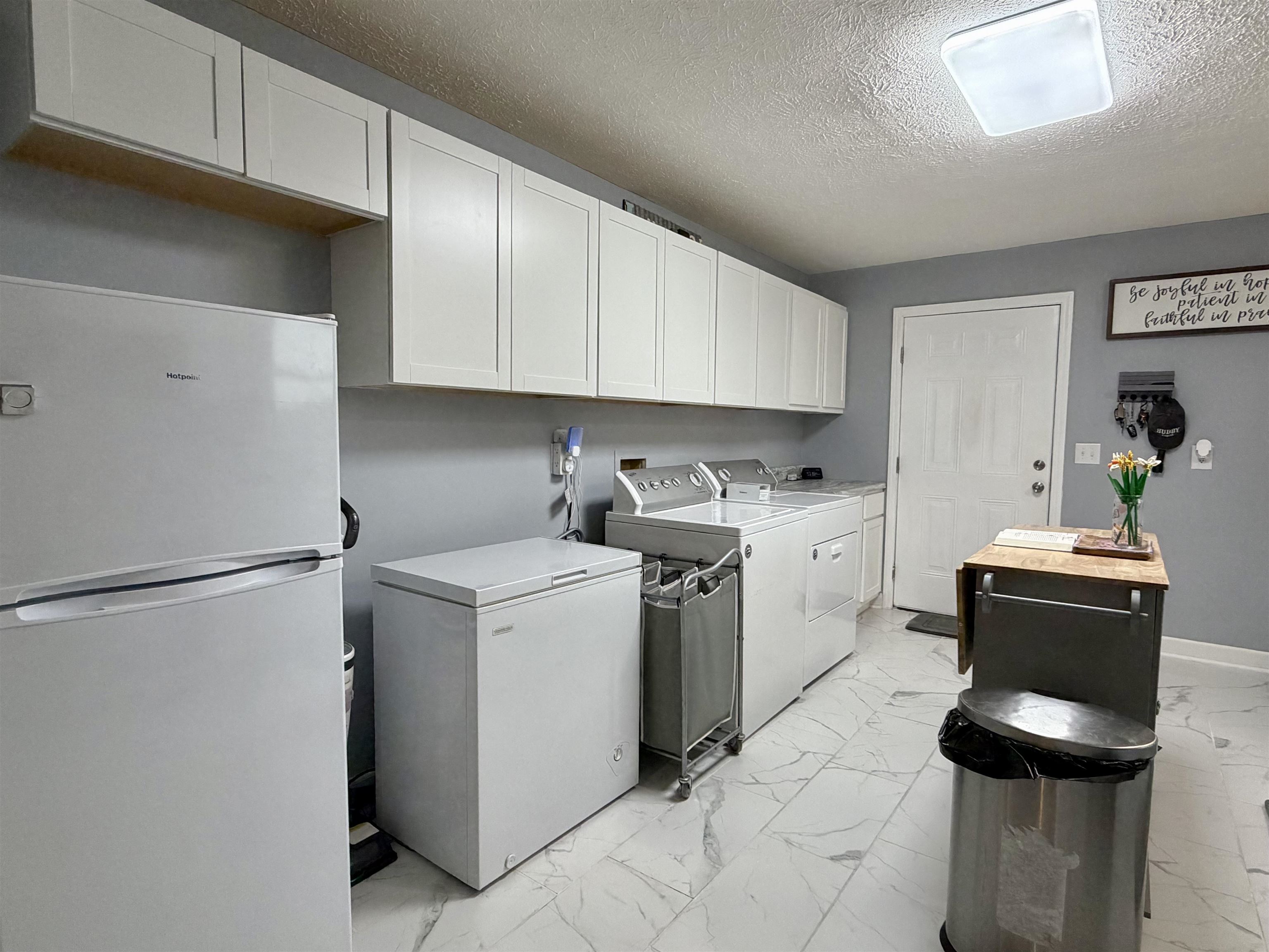 8022 45th Highway Ramer, TN 38367 - Photo 8 of 20 a utility room with cabinets washer and dryer