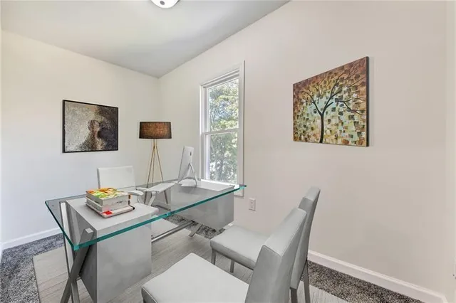 a dining room with table and chair with wooden floor