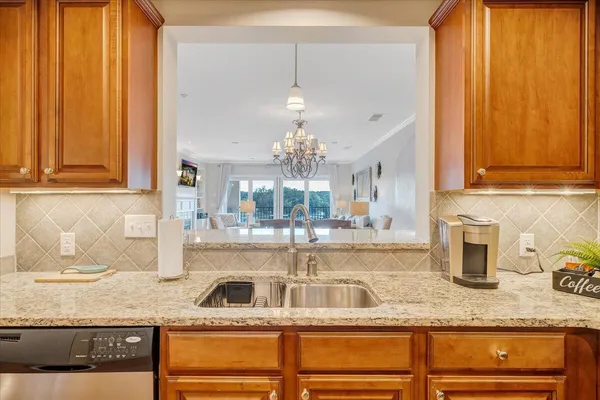 a kitchen with stainless steel appliances granite countertop a sink and cabinets