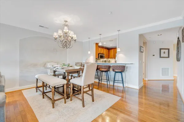 a view of a dining room with furniture and chandelier
