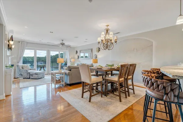 a view of a dining room with furniture wooden floor and chandelier