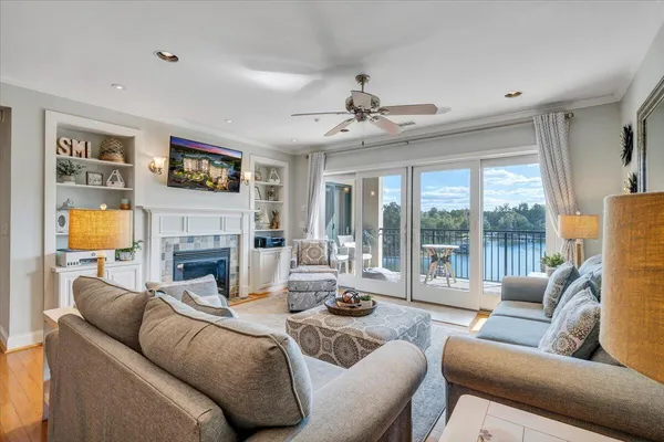 a living room with furniture fireplace and a large window