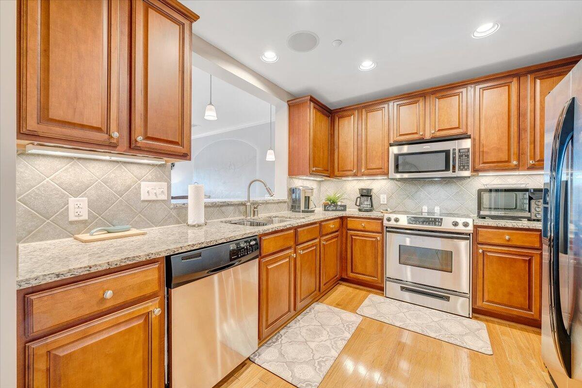 100 Bridgewater Pointe Place, Unit 502 Moneta, VA 24121 - Photo 3 of 54 a kitchen with stainless steel appliances granite countertop a stove a sink and a microwave