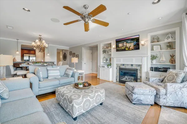 a living room with furniture fireplace and a chandelier