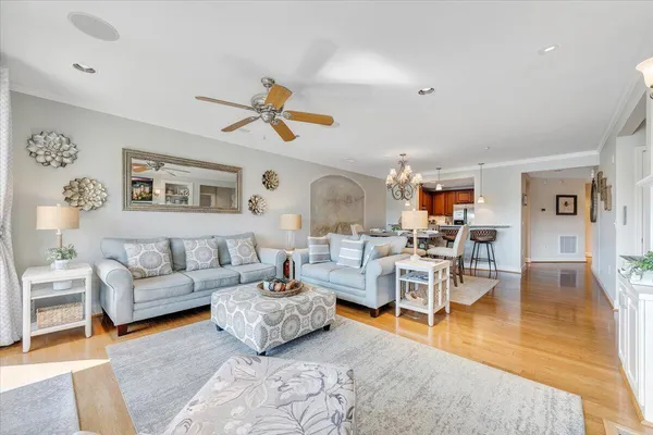 a living room with furniture wooden floor and dining table