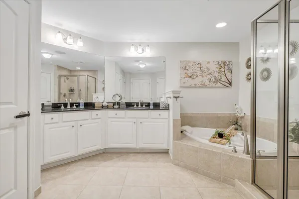 a bathroom with a tub shower and a sink