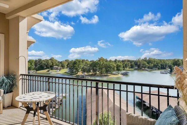 a view of a balcony with wooden chairs