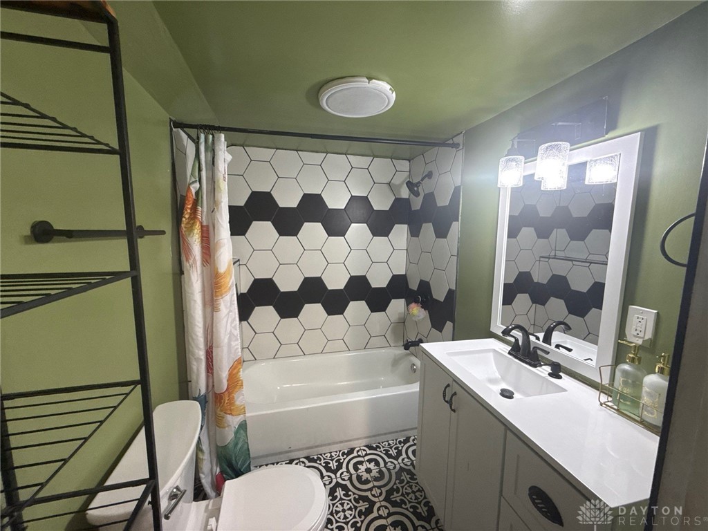 1125 West High Street Springfield, OH 45506 - Photo 16 of 39 This bathroom features unique patterned tile work and a functional vanity for everyday convenience.