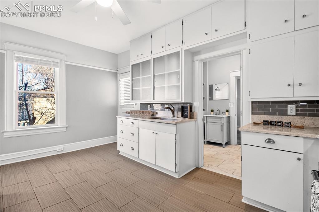 4 West Harrison Street Colorado Springs, CO 80907 - Photo 11 of 49 a kitchen with granite countertop white cabinets and white appliances