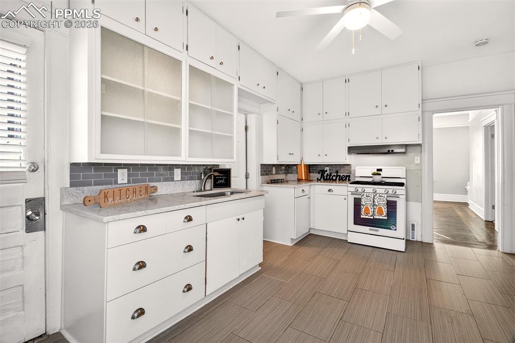 4 West Harrison Street Colorado Springs, CO 80907 - Photo 13 of 49 a kitchen with stainless steel appliances a stove refrigerator and cabinets