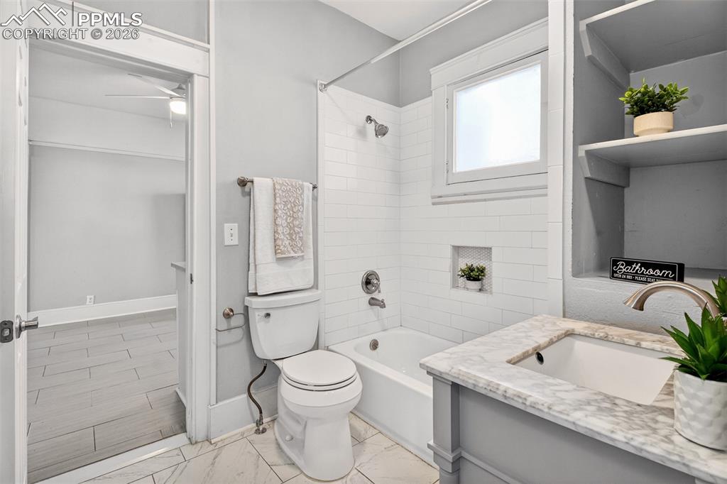 4 West Harrison Street Colorado Springs, CO 80907 - Photo 15 of 49 a bathroom with a granite countertop sink a toilet and shower