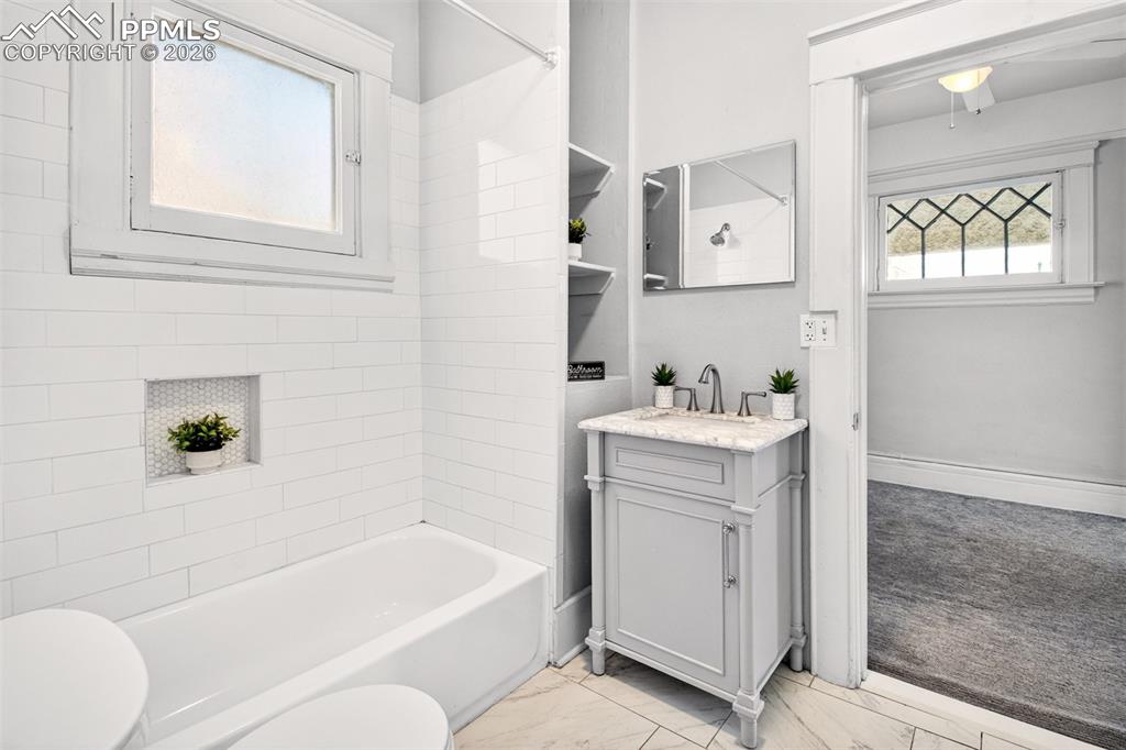 4 West Harrison Street Colorado Springs, CO 80907 - Photo 16 of 49 a bathroom with a bathtub sink vanity mirror and toilet