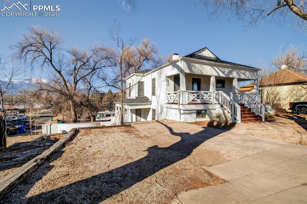 4 West Harrison Street Colorado Springs, CO 80907 - Photo 3 of 49 a front view of a house with a yard covered with snow