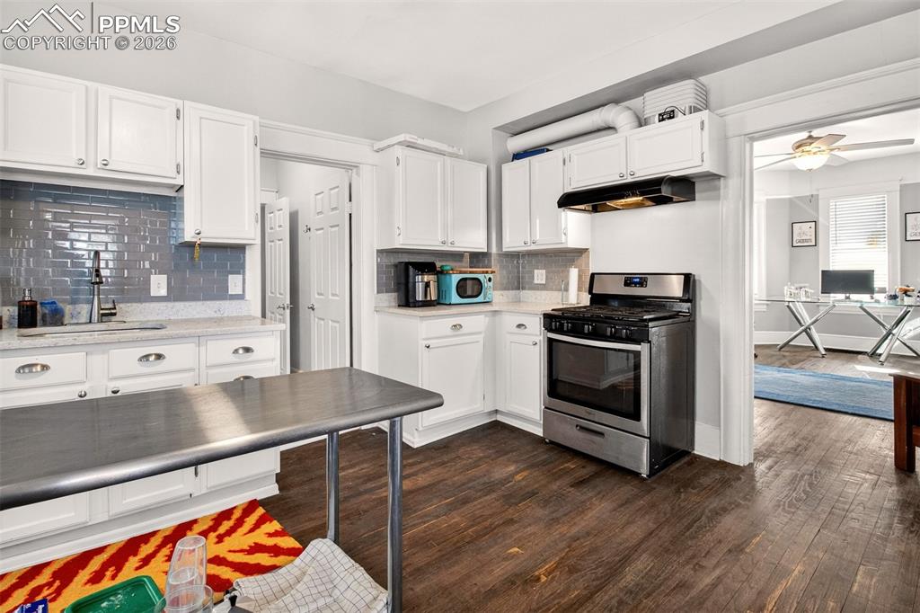 4 West Harrison Street Colorado Springs, CO 80907 - Photo 32 of 49 a kitchen with stainless steel appliances a stove a sink and white cabinets