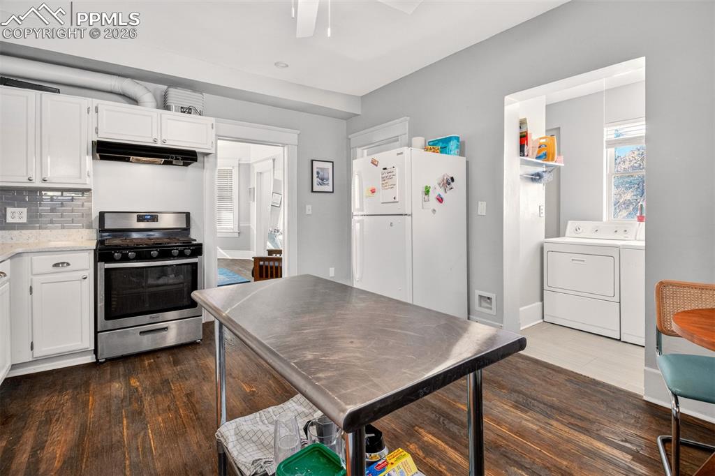 4 West Harrison Street Colorado Springs, CO 80907 - Photo 34 of 49 a kitchen with a stove a refrigerator and a stove top oven
