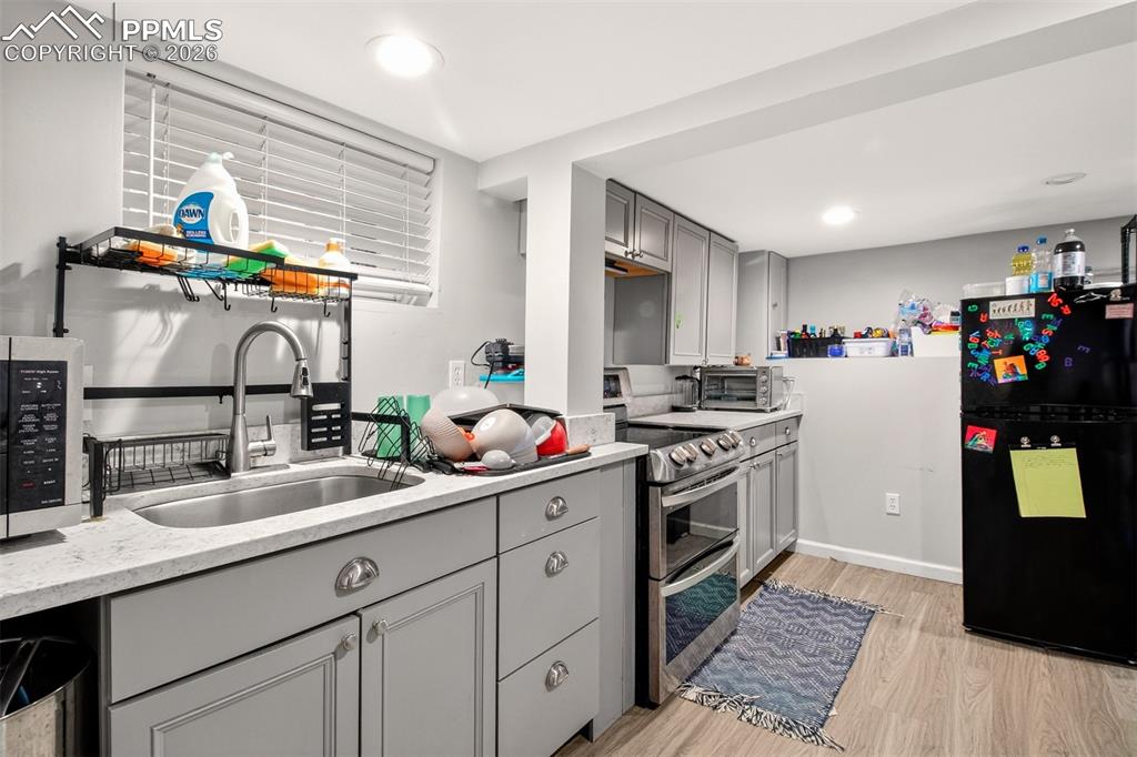 4 West Harrison Street Colorado Springs, CO 80907 - Photo 41 of 49 a kitchen with a sink cabinets and wooden floor