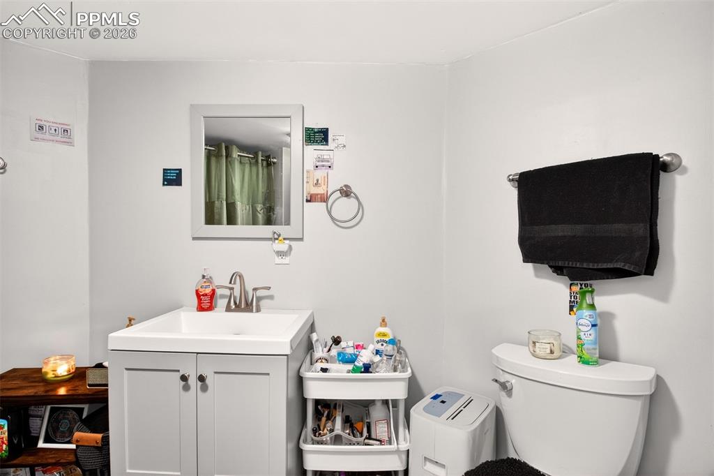 4 West Harrison Street Colorado Springs, CO 80907 - Photo 44 of 49 a bathroom with a toilet sink and mirror