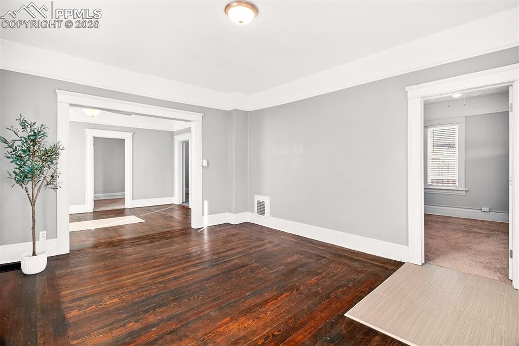 4 West Harrison Street Colorado Springs, CO 80907 - Photo 8 of 49 a view of an empty room with wooden floor and a window