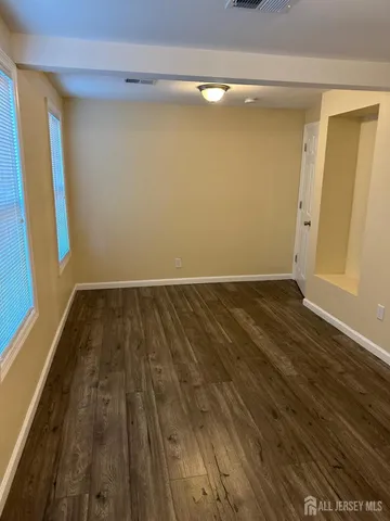 a view of a room with wooden floor and staircase