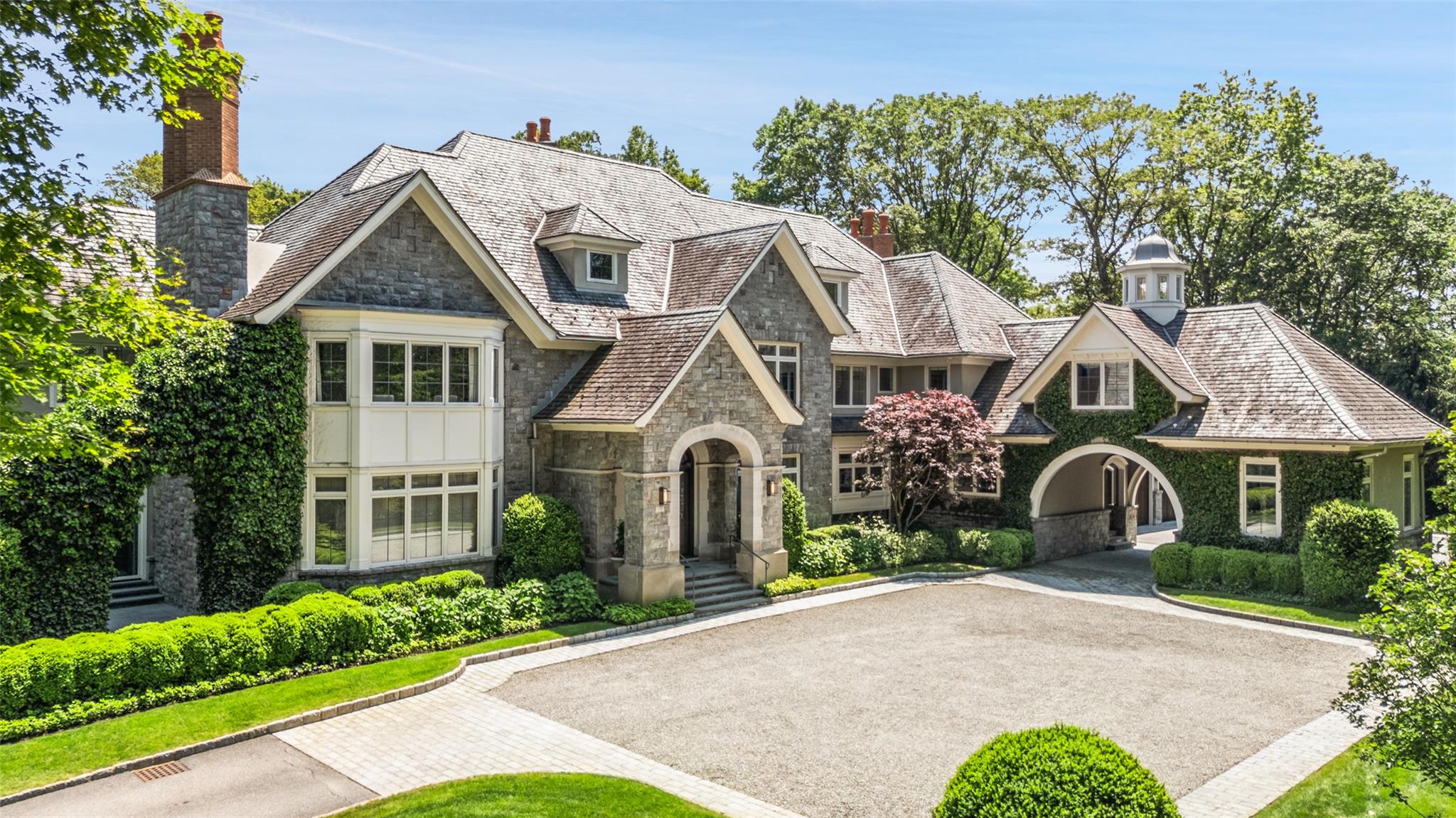 3 Terrace Circle Armonk, NY 10504 - Photo 1 of 1 View of front facade featuring stone siding, a chimney, and a high end roof