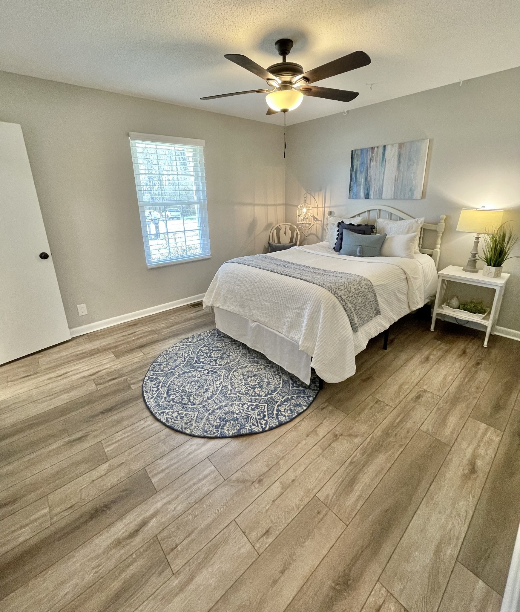 205 Wesley Chapel Road Lawrenceburg, TN 38464 - Photo 15 of 51 a bedroom with a bed and a chandelier