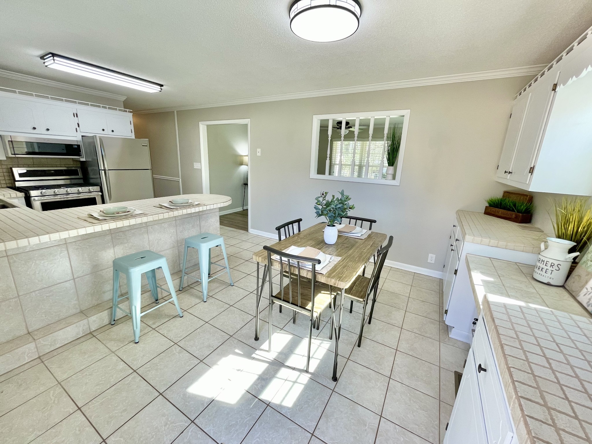 205 Wesley Chapel Road Lawrenceburg, TN 38464 - Photo 8 of 51 a kitchen with a table chairs and a refrigerator