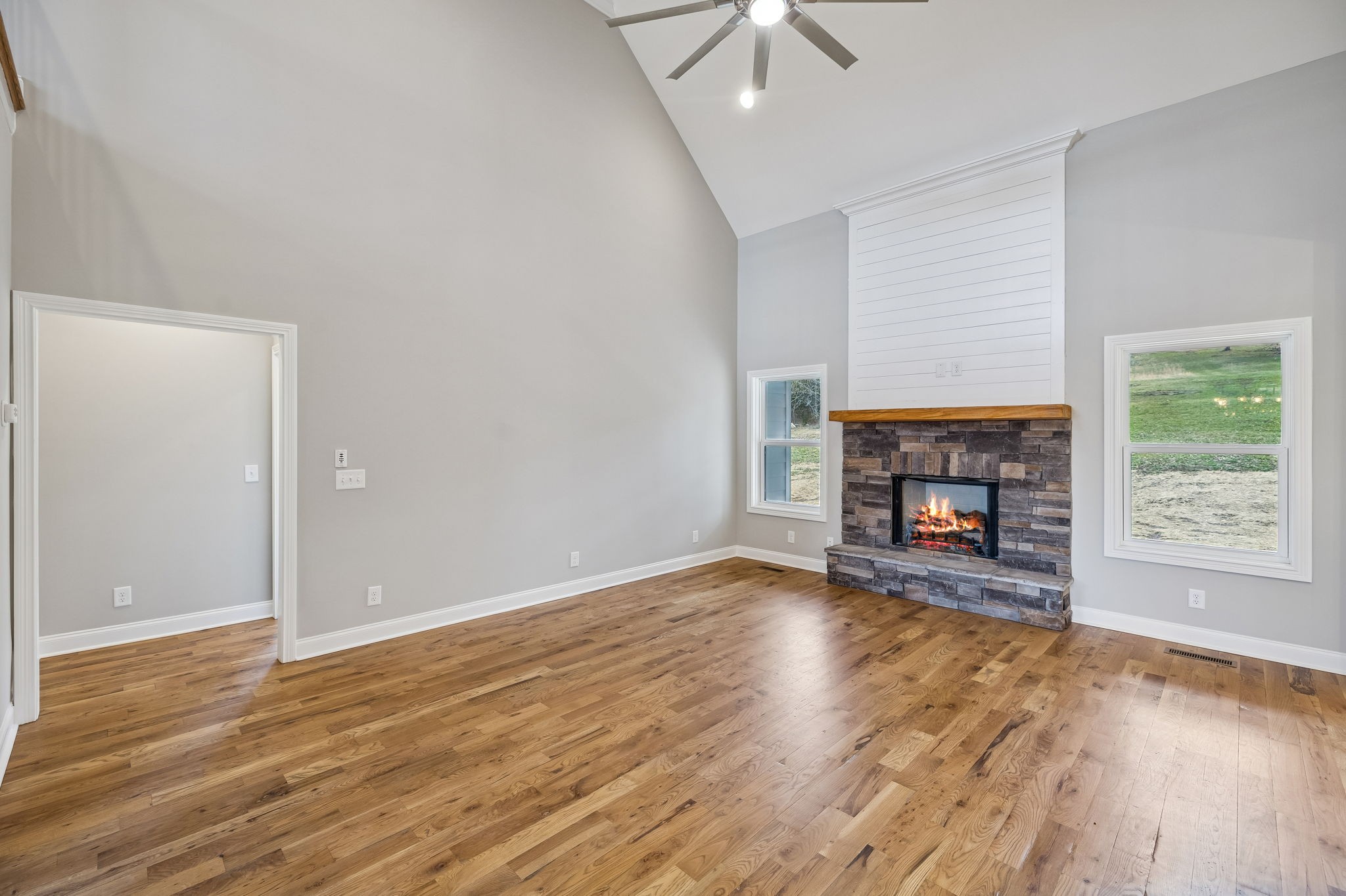 13821 Cainsville Road Lebanon, TN 37090 - Photo 12 of 68 an empty room with wooden floor fireplace and window