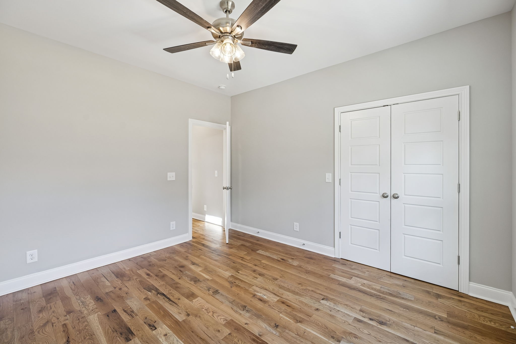 13821 Cainsville Road Lebanon, TN 37090 - Photo 26 of 68 an empty room with wooden floor a ceiling fan and closet