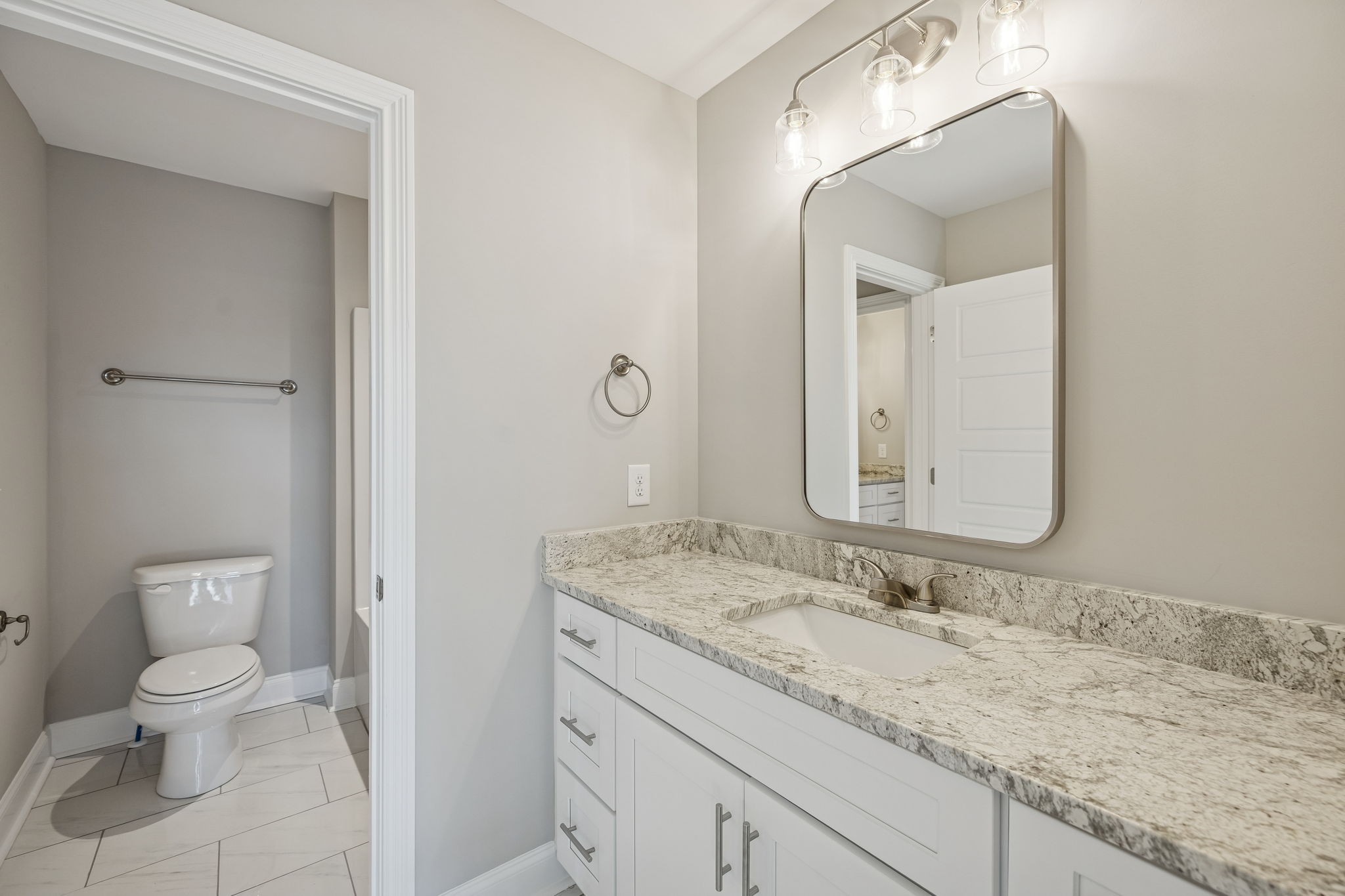 13821 Cainsville Road Lebanon, TN 37090 - Photo 46 of 68 a bathroom with a granite countertop sink a toilet and a mirror