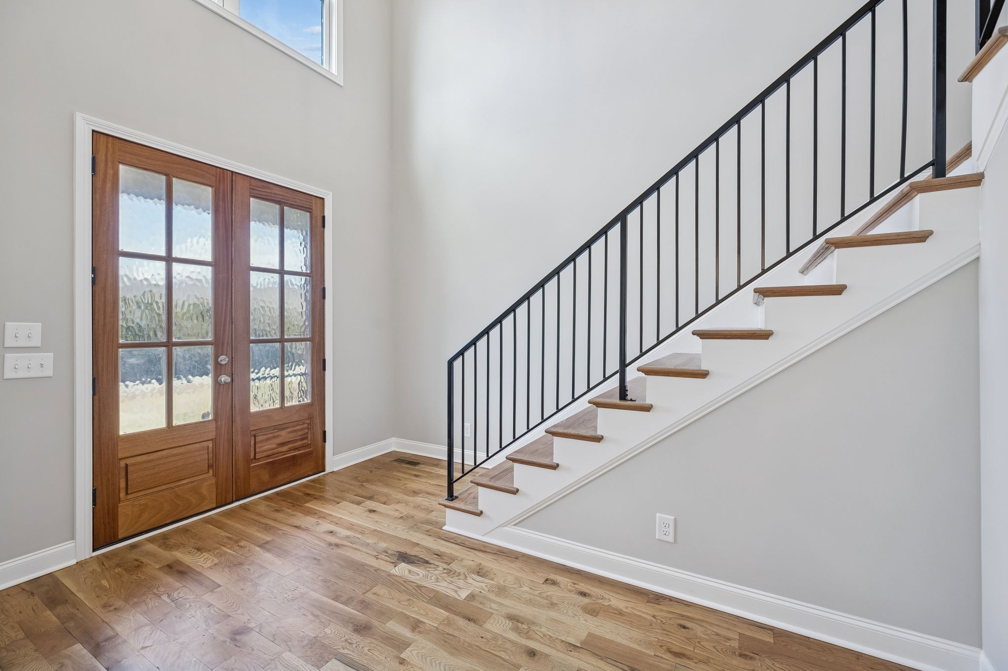 13821 Cainsville Road Lebanon, TN 37090 - Photo 8 of 68 a view of an entryway with wooden floor leading to a furnished livingroom and windows