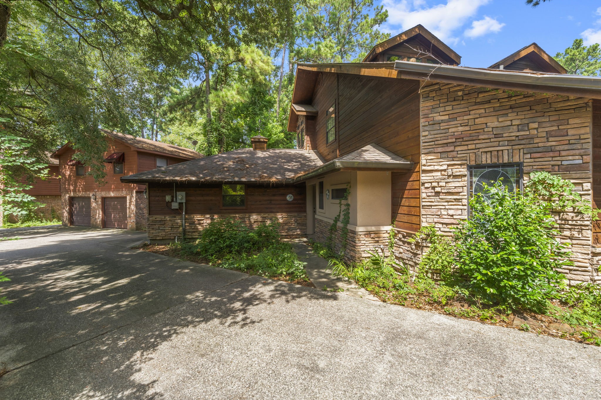 426 Nursery Road The Woodlands, TX 77380 - Photo 16 of 41 a front view of a house with a yard and garage