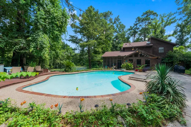 a view of a swimming pool with a yard