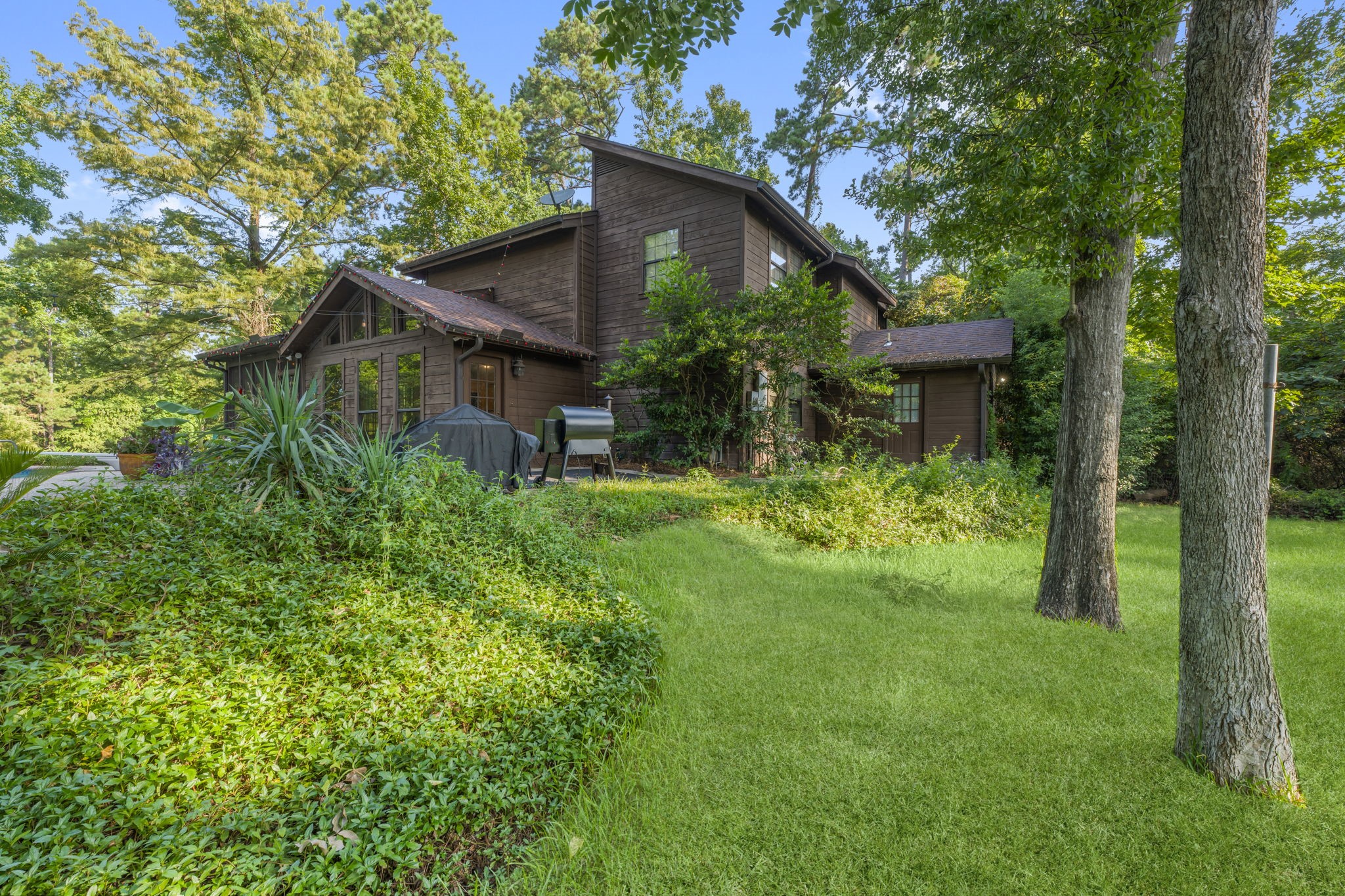 426 Nursery Road The Woodlands, TX 77380 - Photo 23 of 41 a backyard of a house with plants and large trees