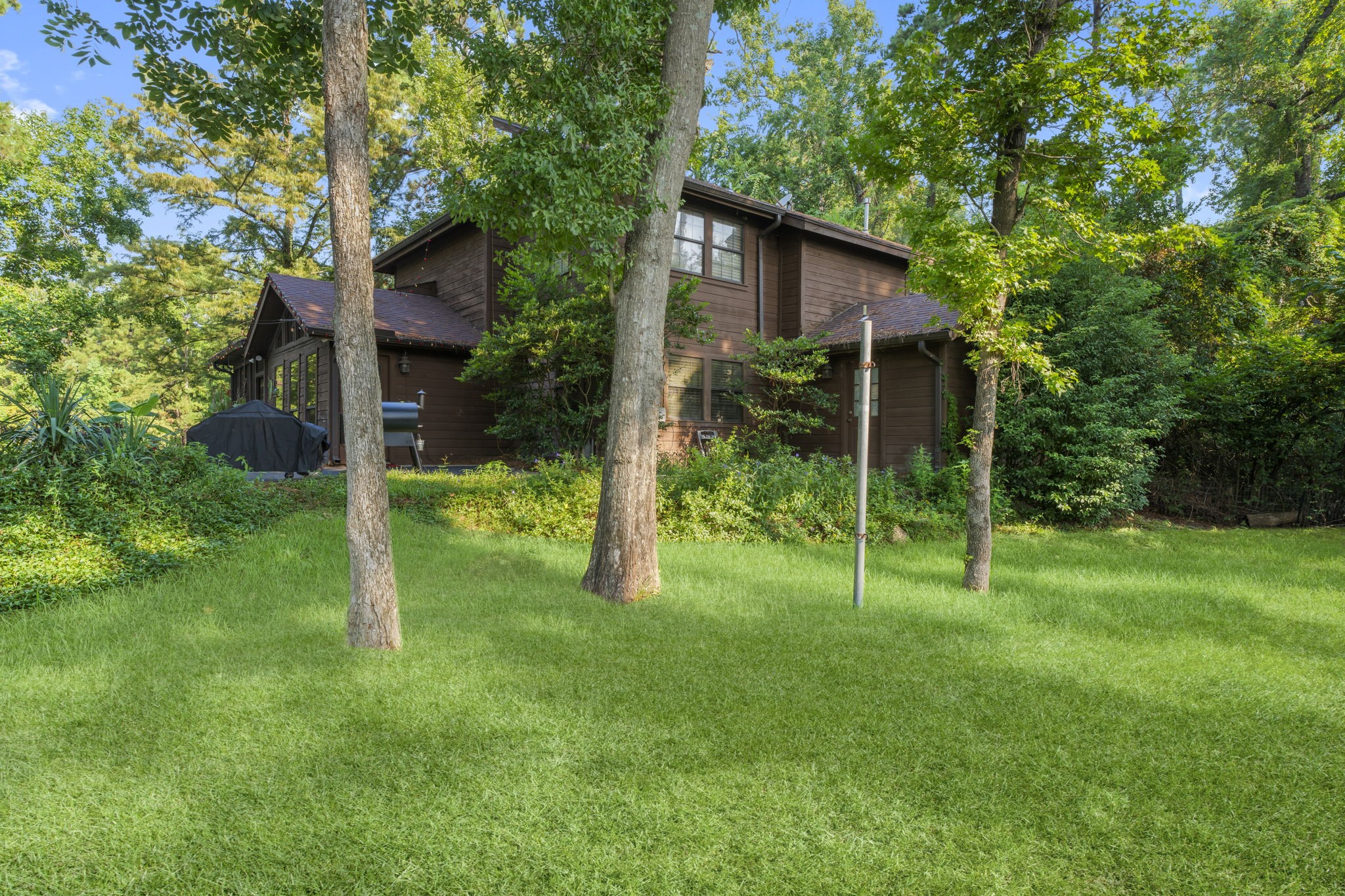 426 Nursery Road The Woodlands, TX 77380 - Photo 24 of 41 a view of a wooden house and a backyard