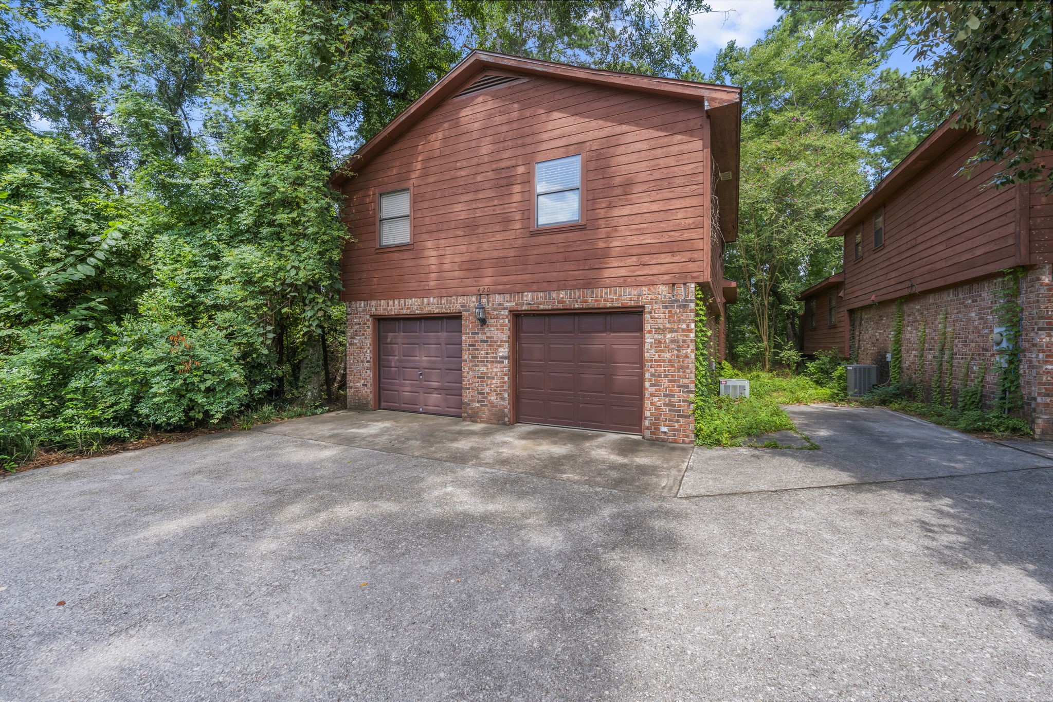 426 Nursery Road The Woodlands, TX 77380 - Photo 7 of 41 a front view of a house with a yard and garage