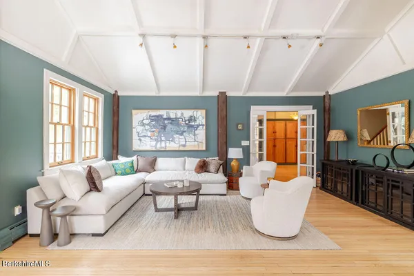 a view of a room with wooden floor and window