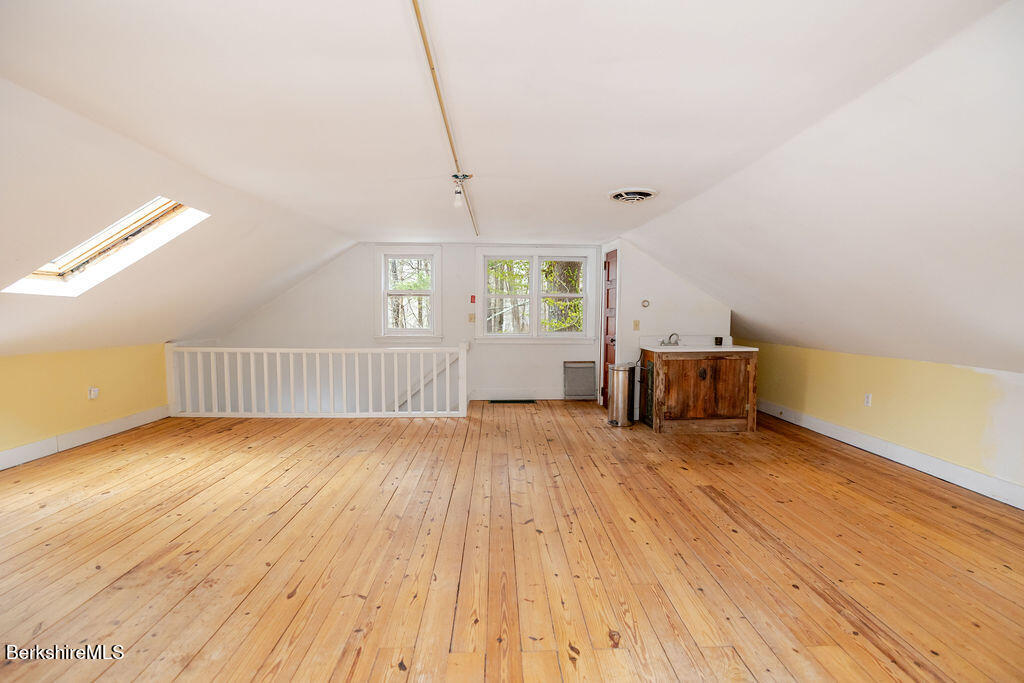 17 Cronk Road Monterey, MA 01245 - Photo 54 of 79 a view of an empty room with a window and wooden floor