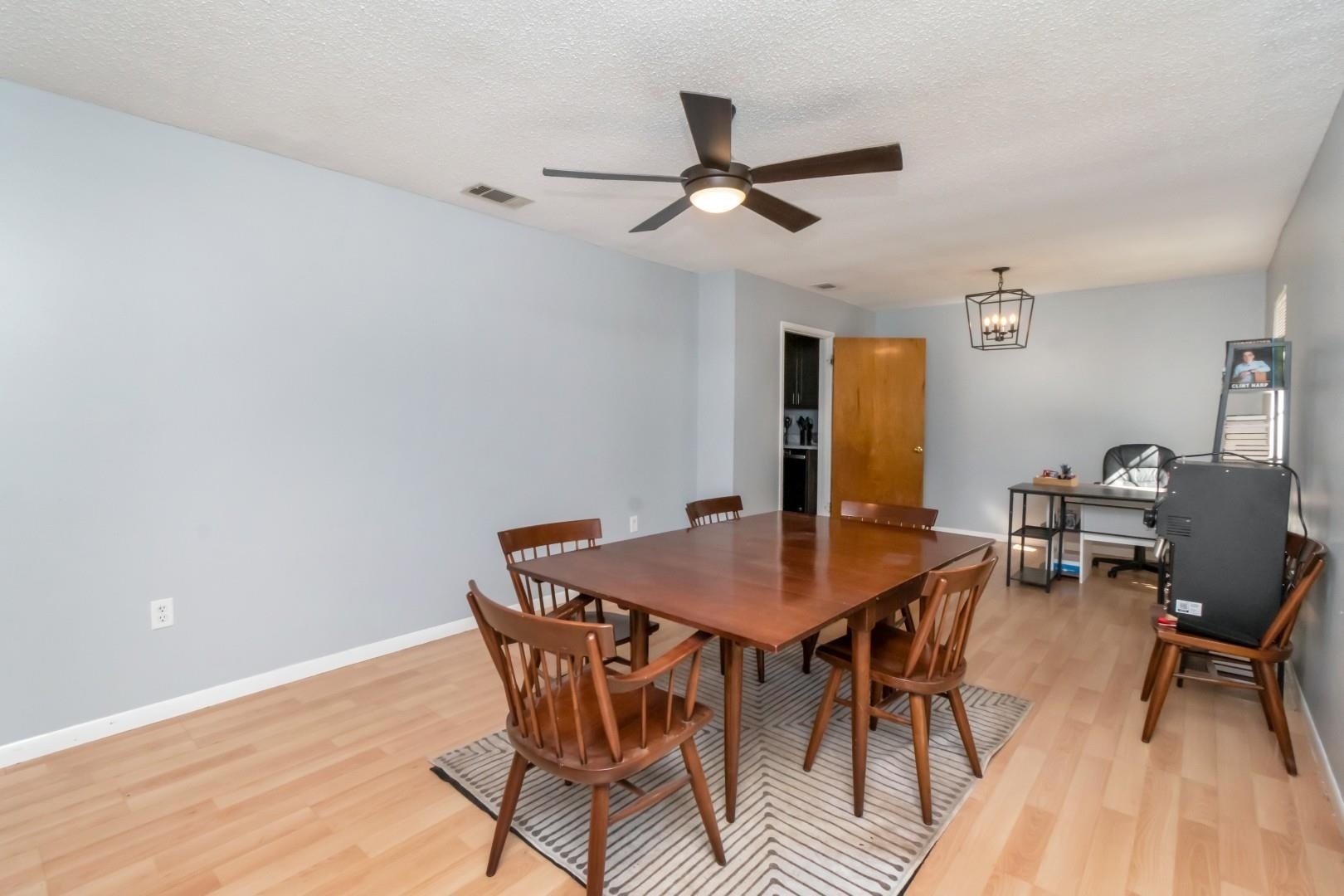 6405 1st Street Wilmer, AL 36587 - Photo 6 of 38 Dining area featuring light wood-style flooring, a textured ceiling, a ceiling fan, and a chandelier