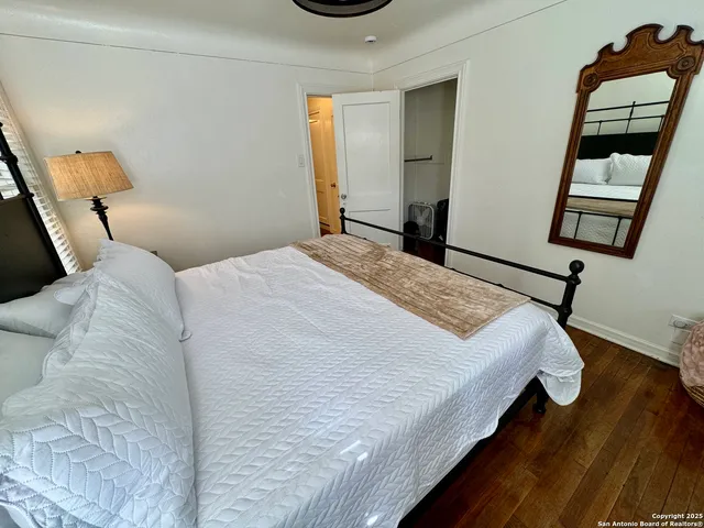 a bedroom with a bed and a mirror